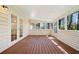 Relaxing screened porch featuring wood floors and lots of natural light streaming through the windows at 3435 Stallion Ct, Powder Springs, GA 30127