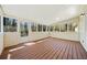Enclosed sunroom features wood-paneled walls, wood floor, and natural light at 3435 Stallion Ct, Powder Springs, GA 30127