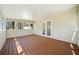Enclosed sunroom features wood-paneled walls, wood floor, and double doors at 3435 Stallion Ct, Powder Springs, GA 30127