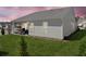 Exterior view of home at dusk, showcasing covered patio and well-maintained lawn at 41 Balsam Dr, Dallas, GA 30157