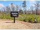 Sign indicating walking trails through a picturesque natural setting with young pine trees at 41 Balsam Dr, Dallas, GA 30157