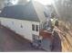Back view showcasing a home with a two-story deck and a wooded backdrop at 70 Trelawney Cir, Covington, GA 30016