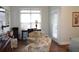 Bedroom with wood floors, sitting area, desk, and natural light from the large window at 70 Trelawney Cir, Covington, GA 30016