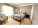 Cozy bedroom featuring a four-poster bed and patterned walls at 70 Trelawney Cir, Covington, GA 30016