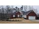Charming brick home with a well-manicured lawn and attached two car garage at 70 Trelawney Cir, Covington, GA 30016