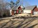 Lovely home featuring brick accents, a manicured lawn, and an attached garage at 70 Trelawney Cir, Covington, GA 30016