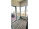 Enclosed porch with wood flooring and access to outdoor grill at 70 Trelawney Cir, Covington, GA 30016
