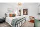 Well-lit bedroom featuring a modern metal frame bed, designer pillows, and rustic decor at 113 Windsong Trl, Canton, GA 30114