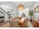 Elegant dining room with stylish chandelier, table set for six, and views of the entryway at 113 Windsong Trl, Canton, GA 30114