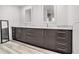 Modern bathroom with double sink vanity, marble countertop, and wood-look tile flooring at 1552 Newton Se Ave, Atlanta, GA 30316