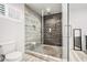Contemporary bathroom with glass-enclosed shower, pebble floor, and wood-look tile accent wall at 1552 Newton Se Ave, Atlanta, GA 30316
