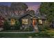 Charming home featuring landscaped front yard and cozy seating area, bathed in the warm colors of a sunset sky at 1552 Newton Se Ave, Atlanta, GA 30316