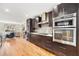 Modern kitchen with stainless steel appliances, sleek dark cabinetry, and hardwood flooring at 1552 Newton Se Ave, Atlanta, GA 30316