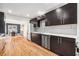 Elegant kitchen featuring dark cabinets, stainless steel appliances, and hardwood floors at 1552 Newton Se Ave, Atlanta, GA 30316