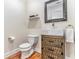 Cozy powder room with wood floors, toilet, and stylish sink with vessel faucet at 1552 Newton Se Ave, Atlanta, GA 30316