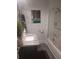 Stylish bathroom with a marble countertop, elegant faucet, and subway tile in the shower area at 3060 Pharr Court North Nw # 306, Atlanta, GA 30305