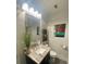 Elegant bathroom features a marble vanity, decorative mirror, and modern lighting fixture at 3060 Pharr Court North Nw # 306, Atlanta, GA 30305
