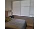 Sunlit bedroom featuring a bed with a decorative pillow next to a window at 3060 Pharr Court North Nw # 306, Atlanta, GA 30305