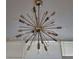 Unique starburst chandelier with decorative bulbs and crystal accents creates a striking focal point at 3060 Pharr Court North Nw # 306, Atlanta, GA 30305
