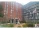 Tall brick Habersham Estates building featuring an American flag and mature landscaping at 3060 Pharr Court North Nw # 306, Atlanta, GA 30305