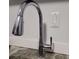 Close-up of a modern chrome kitchen faucet and granite countertop at 3060 Pharr Court North Nw # 306, Atlanta, GA 30305