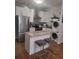 Charming kitchen featuring stainless steel appliances, an island with seating, and a stacked washer/dryer at 3060 Pharr Court North Nw # 306, Atlanta, GA 30305