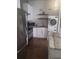 Compact kitchen featuring stainless steel appliances, granite counters, and in-unit washer/dryer at 3060 Pharr Court North Nw # 306, Atlanta, GA 30305