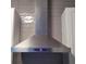 Close-up view of stainless steel range hood with digital display against gray tiled backsplash at 3060 Pharr Court North Nw # 306, Atlanta, GA 30305