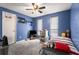 Cozy bedroom with blue walls, ceiling fan, and large windows for natural light at 3747 Junior Ln, Douglasville, GA 30135