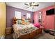 Colorful bedroom featuring a ceiling fan, windows, and a cozy bed at 3747 Junior Ln, Douglasville, GA 30135
