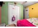 Bright bedroom with double closets, pink blanket and multi-colored walls at 3747 Junior Ln, Douglasville, GA 30135