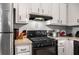 Traditional kitchen featuring white cabinets, black appliances, and efficient layout at 3747 Junior Ln, Douglasville, GA 30135