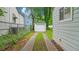 Backyard view of garage and house with driveway and grassy dividers at 1132 Fair St, Atlanta, GA 30314