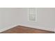 This bedroom has a window, white trim, dark wood floors and light grey walls at 1132 Fair St, Atlanta, GA 30314