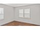 Bedroom with two windows with blinds, dark wood floors and white trim at 1132 Fair St, Atlanta, GA 30314