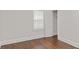Bright bedroom with dark wood floors and white trim, plus a closet with open door at 1132 Fair St, Atlanta, GA 30314