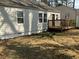 Cozy home exterior with a wood deck, neutral siding, and green lawn around the perimeter at 1132 Fair St, Atlanta, GA 30314