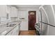 Updated kitchen featuring stainless steel appliances, granite countertops, and dark stained doors at 1132 Fair St, Atlanta, GA 30314