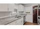 Updated kitchen featuring stainless steel appliances, granite countertops, and dark stained doors at 1132 Fair St, Atlanta, GA 30314
