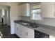 Modern kitchen featuring stainless steel appliances, granite countertops, and white cabinetry at 1132 Fair St, Atlanta, GA 30314