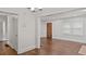 Open living area with dark hardwood floors, white walls, and door to other areas at 1132 Fair St, Atlanta, GA 30314