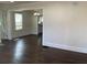 Open-concept living space featuring hardwood floors and lots of natural light, with view to kitchen at 1132 Fair St, Atlanta, GA 30314