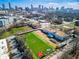 A vibrant green Salvation Army athletic field is set against the backdrop of the Atlanta skyline on a sunny day at 480 James P Brawley Nw Dr, Atlanta, GA 30318