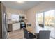 Modern kitchen with stainless steel appliances, granite countertops, and a view to the outside deck at 480 James P Brawley Nw Dr, Atlanta, GA 30318