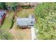 Aerial view of a charming single-story home with a long driveway and mature trees at 1703 Alton Way, Marietta, GA 30062