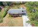 Aerial view of a well-maintained home with a lush lawn, driveway, and mature trees, showcasing its curb appeal at 1703 Alton Way, Marietta, GA 30062