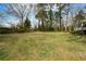 Lush backyard with mature trees, perfect for outdoor activities and relaxation, offers plenty of space for gardening at 1703 Alton Way, Marietta, GA 30062