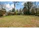 Expansive backyard offers ample space for outdoor activities and gardening, complemented by mature trees and lush greenery at 1703 Alton Way, Marietta, GA 30062