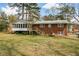 Brick home with a spacious backyard, complete with a screened in porch and deck, perfect for Gathering gatherings at 1703 Alton Way, Marietta, GA 30062