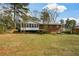 Brick home with a spacious backyard, complete with a screened in porch and deck, perfect for Gathering gatherings at 1703 Alton Way, Marietta, GA 30062